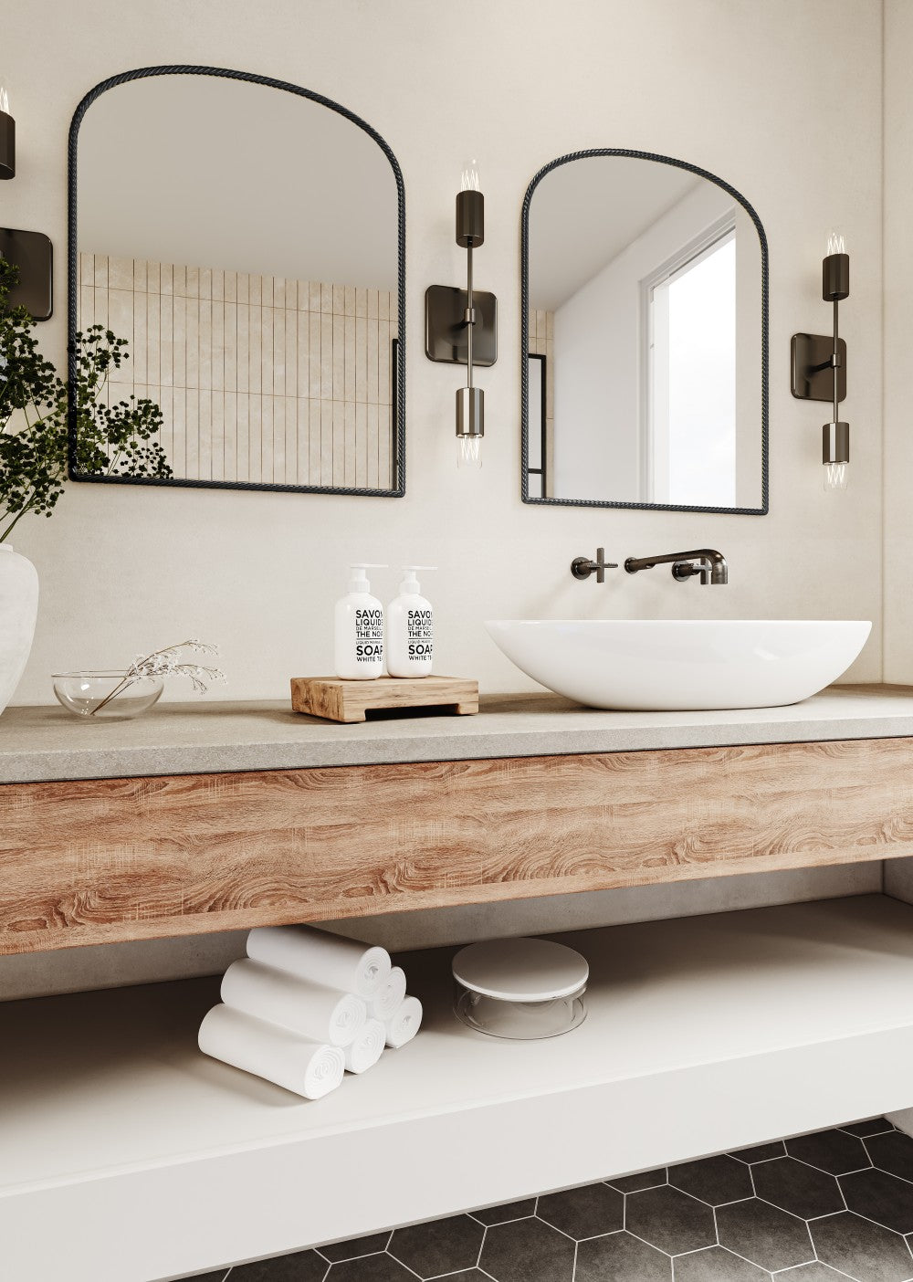 two large arched black metal wall mirrors above a double vanity