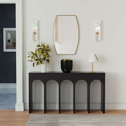 a gold oblong wall mirror above a black console table