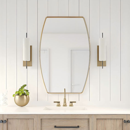 a gold oval mirror above a sink with wood closet