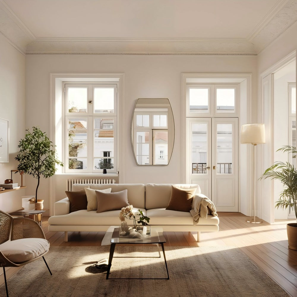 a stylish living room in neutral tones with an oval wall mirror that reflects warm natural light