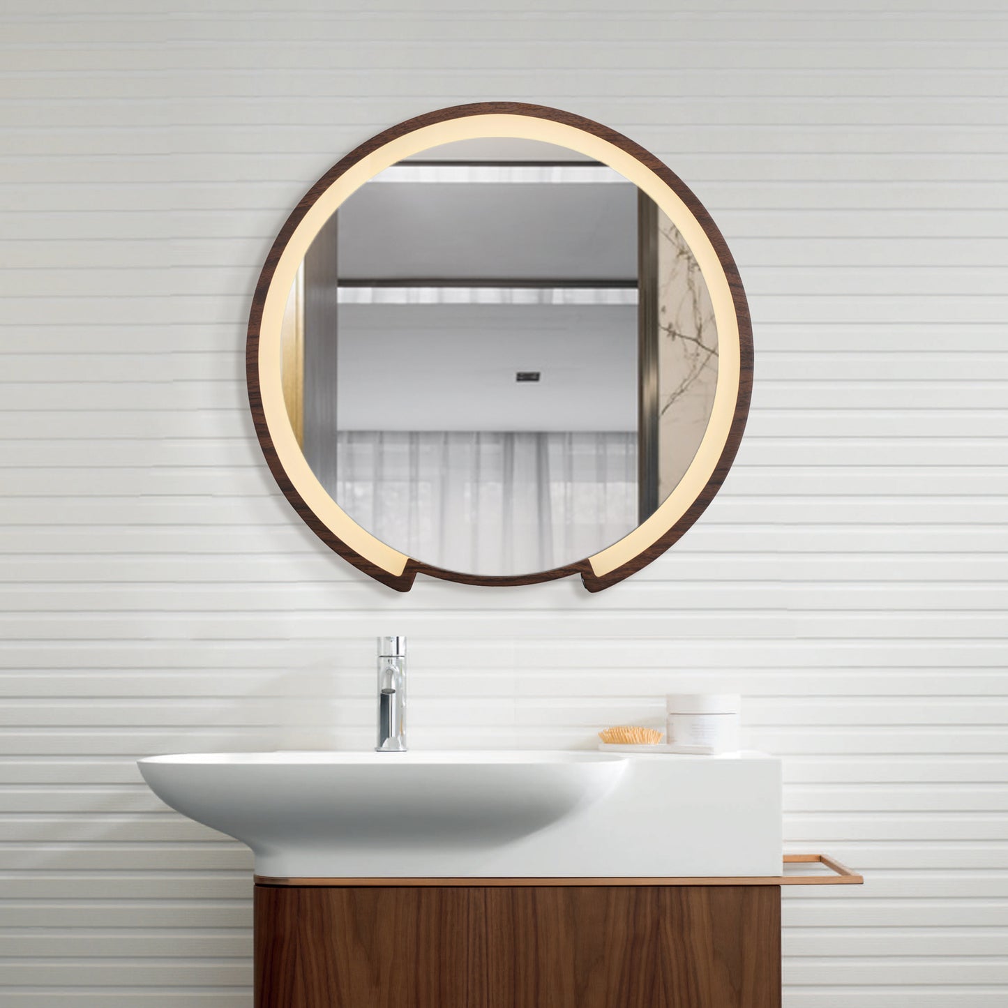 modern bathroom with a round led mirror above a white sink