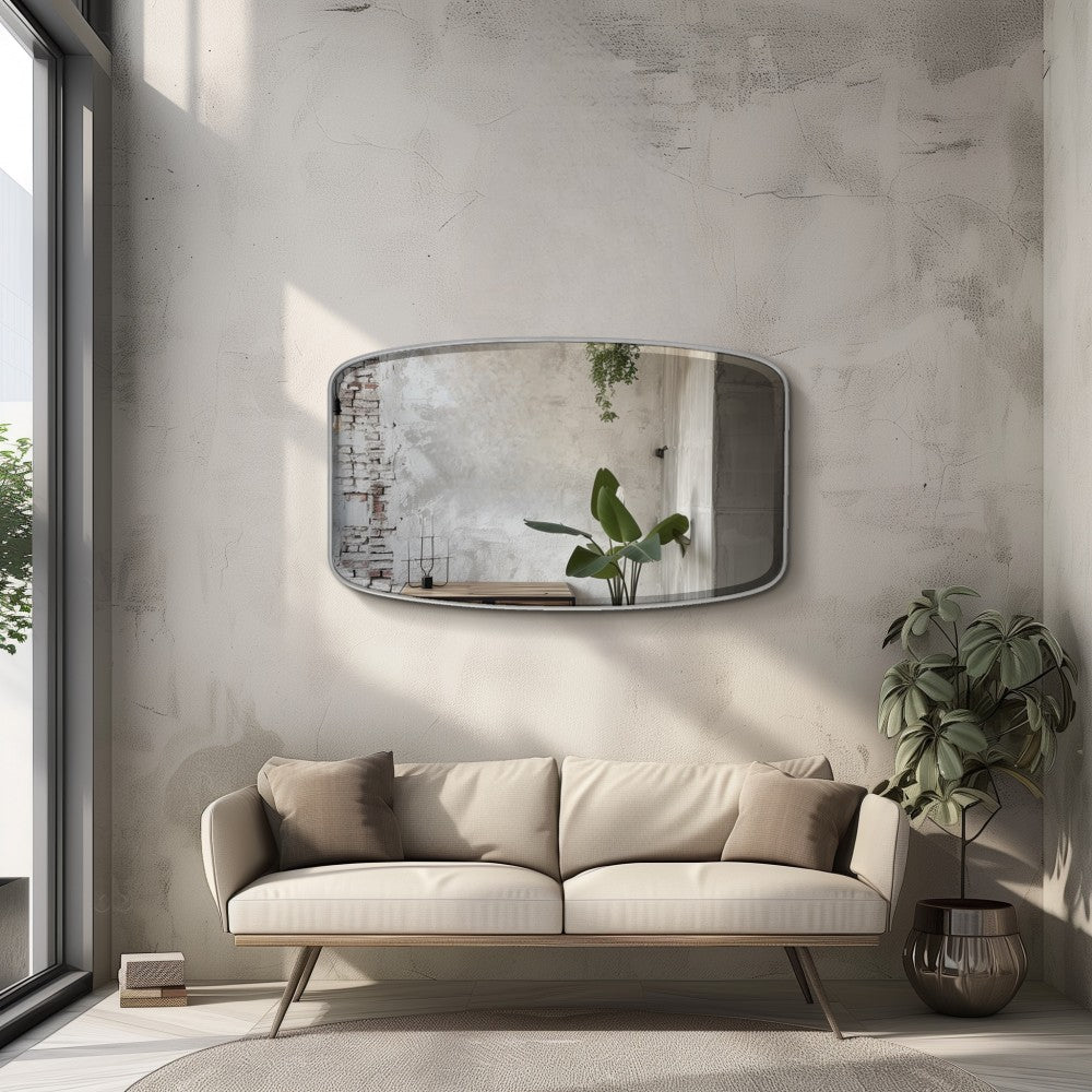 a silver oblong wall mirror above a cream-coloured sofa