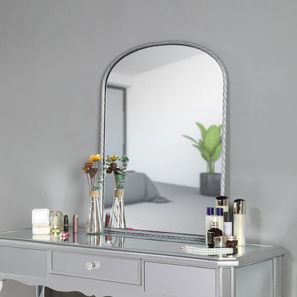 a large silver arch metal wall mirror above a silver table